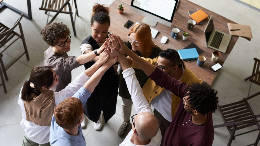 Collaborazione intergenerazionale in azienda tra giovani e senior per innovazione e reputazione 